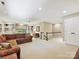 Bright living room with a ceiling fan, built-in shelves, and direct access to stairs at 4701 Pineland Pl, Charlotte, NC 28277