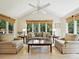 Bright living room featuring a ceiling fan, neutral color palette, and abundant natural light from large windows at 4701 Pineland Pl, Charlotte, NC 28277