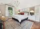 Bright main bedroom with vaulted ceiling, large window, and stylish furnishings at 4701 Pineland Pl, Charlotte, NC 28277