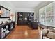 Home office featuring built-in shelves, a large desk, and natural light at 4701 Pineland Pl, Charlotte, NC 28277