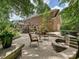 Lush green garden surrounding stone patio with outdoor seating at 4701 Pineland Pl, Charlotte, NC 28277