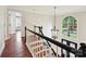 Beautiful staircase with decorative chandelier and large window providing natural light at 4701 Pineland Pl, Charlotte, NC 28277