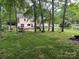 Picturesque backyard with mature trees and a wooden fence, offering a peaceful outdoor retreat at 4905 Montibello Dr, Charlotte, NC 28226