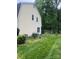 Expansive backyard featuring lush lawn and mature trees, creating a private outdoor space at 4905 Montibello Dr, Charlotte, NC 28226