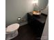 Powder room featuring a vanity with a decorative bowl sink and unique lighting fixture at 4905 Montibello Dr, Charlotte, NC 28226
