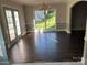 Charming dining area features hardwood flooring, a stylish chandelier, and doors to backyard access at 4905 Montibello Dr, Charlotte, NC 28226