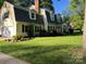 Charming two-story home with a well-maintained lawn and manicured landscaping in a mature neighborhood at 4905 Montibello Dr, Charlotte, NC 28226