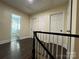 Second floor hallway with hardwood floors, white doors, and trim at 4905 Montibello Dr, Charlotte, NC 28226