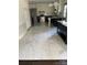 Spacious kitchen featuring white and black cabinets, stainless steel appliances, and modern marble tile flooring at 4905 Montibello Dr, Charlotte, NC 28226