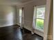 Living room featuring hardwood floors, custom trim, and picturesque windows with natural light at 4905 Montibello Dr, Charlotte, NC 28226