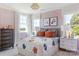 Charming bedroom with floral accents, decorative pillows, and plentiful natural light at 504 Meadow Ridge Dr, Belmont, NC 28012