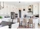 Spacious kitchen with white cabinets, stainless appliances, an island with bar seating, and decorative pendant lights at 504 Meadow Ridge Dr, Belmont, NC 28012
