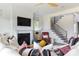 A stylish living room featuring a cozy fireplace and modern staircase at 504 Meadow Ridge Dr, Belmont, NC 28012