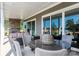 Covered outdoor patio with a stone fireplace, sliding glass doors, and wicker furniture at 504 Meadow Ridge Dr, Belmont, NC 28012