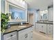 Bathroom with double vanity, stone countertops, and a large decorative mirror at 5603 Ballinard Ln, Charlotte, NC 28277