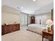 A bright bedroom features neutral walls, plush carpet, and a classic four-poster bed at 5603 Ballinard Ln, Charlotte, NC 28277
