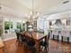 Elegant dining room with hardwood floors, chandelier, and large windows at 5603 Ballinard Ln, Charlotte, NC 28277