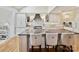 Stylish kitchen with white cabinets, marble backsplash, and a large center island at 5603 Ballinard Ln, Charlotte, NC 28277