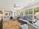 Living room with multiple seating areas, large windows with shutters and decorative carpet at 5603 Ballinard Ln, Charlotte, NC 28277
