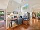 Bright living room with high ceilings, fireplace, and hardwood floors at 5603 Ballinard Ln, Charlotte, NC 28277