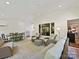 Bright living space with wicker furniture, dining table, white plank ceiling and large windows at 5603 Ballinard Ln, Charlotte, NC 28277