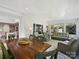 Open living and dining space with farm-style table and wicker furniture, bright natural light at 5603 Ballinard Ln, Charlotte, NC 28277