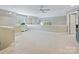 Upstairs loft with plush carpet, bright light, and extra room at 5603 Ballinard Ln, Charlotte, NC 28277
