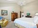 Bright main bedroom with tall ceilings, ceiling fan, artwork, and plush chair at 5603 Ballinard Ln, Charlotte, NC 28277