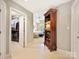 View from entry hall to main bedroom, showing walk-in closet, tile floor, and built-in shelf at 5603 Ballinard Ln, Charlotte, NC 28277