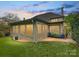 A covered patio with brick flooring is surrounded by lush green lawn and landscaping at dusk at 5603 Ballinard Ln, Charlotte, NC 28277