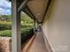 Covered brick walkway with manicured hedges leading to the front entrance at 5603 Ballinard Ln, Charlotte, NC 28277