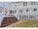 Backyard deck featuring a pergola, white railings, and brown stairs, offering a cozy outdoor living space at 5745 Snapdragon Ln, Huntersville, NC 28078