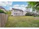 Large backyard showcasing the home's exterior, deck with pergola, and spacious grassy area at 5745 Snapdragon Ln, Huntersville, NC 28078