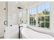Bright bathroom features a soaking tub and a glass enclosed shower with rain shower head at 5745 Snapdragon Ln, Huntersville, NC 28078