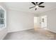 Spacious, neutral bedroom featuring a ceiling fan and an adjacent bathroom with modern finishes at 5745 Snapdragon Ln, Huntersville, NC 28078