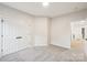 Bedroom featuring new carpet, base trim, neutral walls and a closet with double doors at 5745 Snapdragon Ln, Huntersville, NC 28078