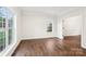 Bedroom featuring hardwood floors, two bright windows, and an open doorway to another room at 5745 Snapdragon Ln, Huntersville, NC 28078