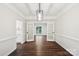 Elegant dining room featuring hardwood floors and modern lighting fixture open to another room at 5745 Snapdragon Ln, Huntersville, NC 28078