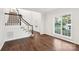 Bright foyer with hardwood floors, staircase, and large window offers a welcoming entrance to the home at 5745 Snapdragon Ln, Huntersville, NC 28078