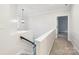 Hallway with carpeted floors and a staircase, with a view of a window on the landing at 5745 Snapdragon Ln, Huntersville, NC 28078