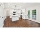 Bright kitchen with white cabinetry, central island, stainless steel appliances, and hardwood flooring at 5745 Snapdragon Ln, Huntersville, NC 28078