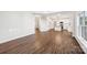 Open-concept living area featuring hardwood floors flowing into the kitchen, with ample space for gathering at 5745 Snapdragon Ln, Huntersville, NC 28078