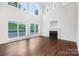 Bright living room with a fireplace, hardwood floors and large windows offer natural light and scenic views at 5745 Snapdragon Ln, Huntersville, NC 28078