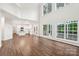 Spacious living area with hardwood floors and large windows adjacent to the modern kitchen, providing bright and airy spaces at 5745 Snapdragon Ln, Huntersville, NC 28078