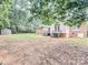 Expansive backyard with shed in the distance, and steps leading to back of house at 6231 Kentwood Dr, Kannapolis, NC 28081
