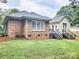 A view of the backyard, with brick and siding walls and a set of stairs at 6231 Kentwood Dr, Kannapolis, NC 28081