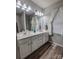 Bathroom with double sink vanity, wood-look floors, and stylish decor at 6231 Kentwood Dr, Kannapolis, NC 28081