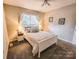 Comfortable carpeted bedroom with a queen bed, lamps, and closet at 6231 Kentwood Dr, Kannapolis, NC 28081