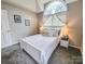 Bedroom featuring an arched window, queen bed, lamps, and carpet floors at 6231 Kentwood Dr, Kannapolis, NC 28081