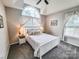 Carpeted bedroom featuring a queen bed, lamps, and natural light at 6231 Kentwood Dr, Kannapolis, NC 28081